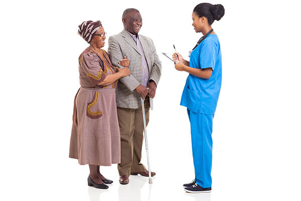 Young african american nurse talking to elderly couple